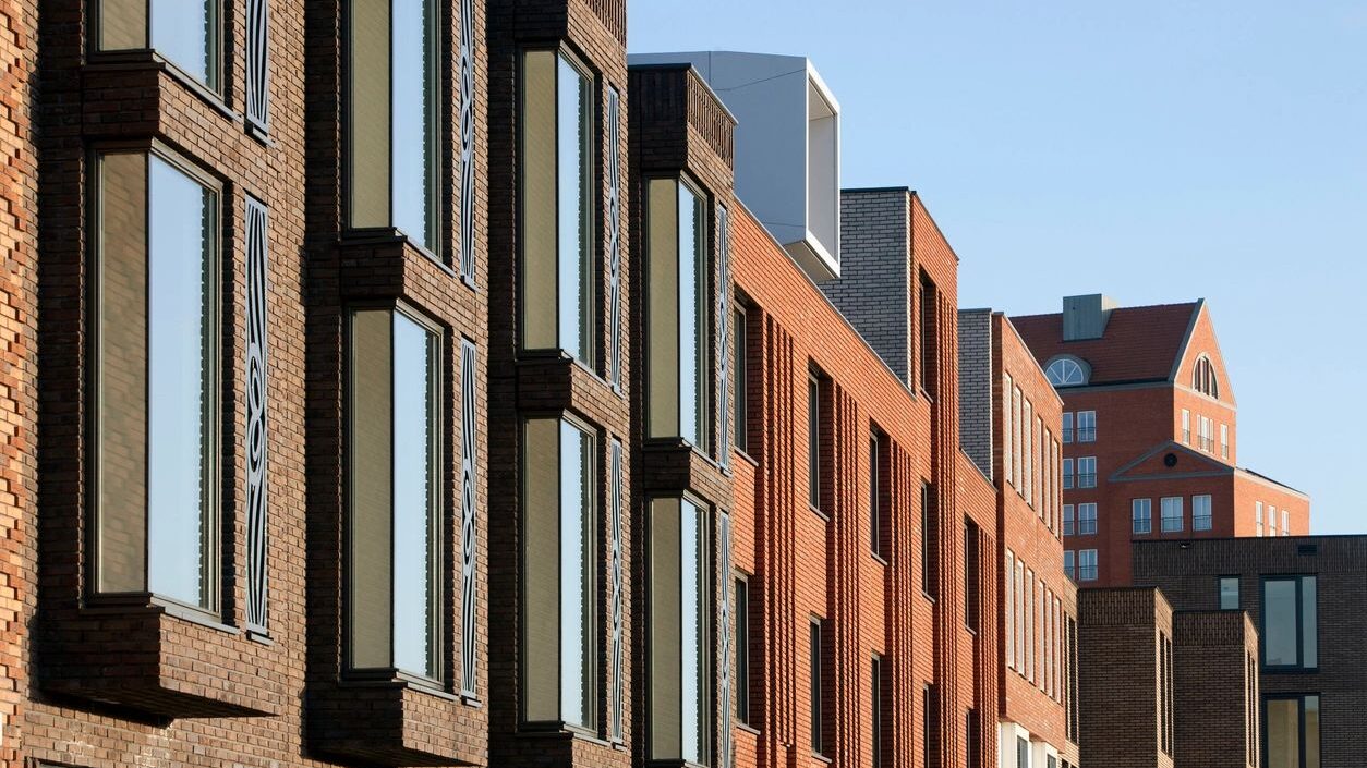 Close-up skyline of several apartment buildings along a city block.