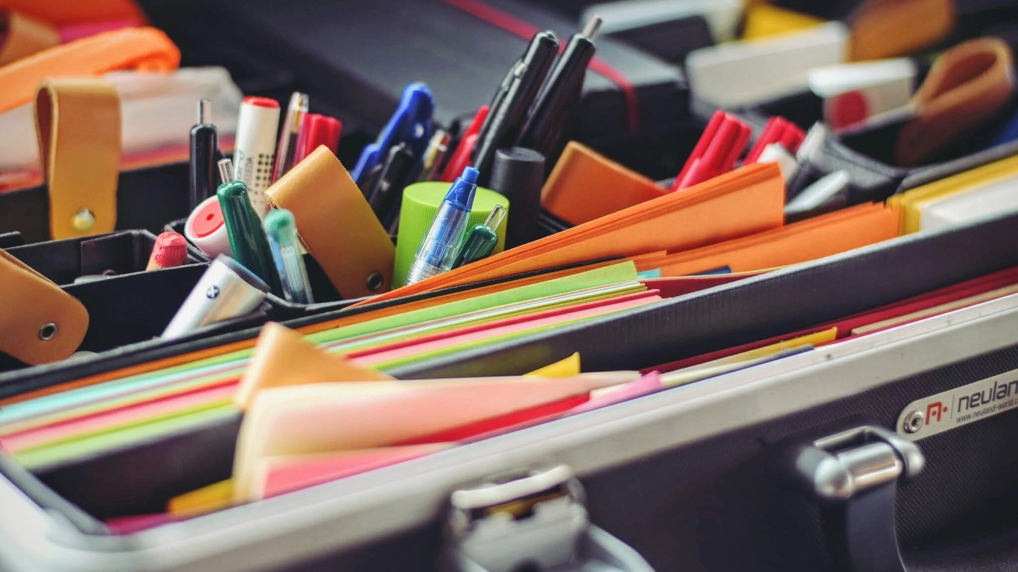 A briefcase full of office supplies.